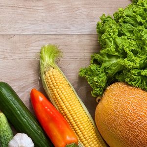 picture of vegetables and fruits including corn, pepper, pumpkin and cucumber